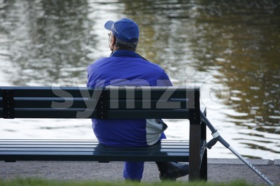 Elderly Man Sitting on a Bench Stock Photo