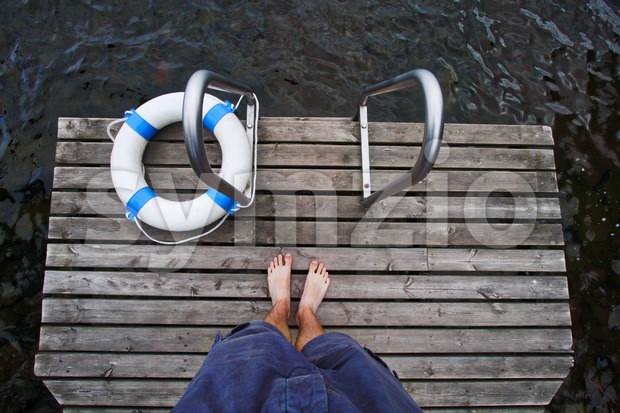 Boy Standing on the Dock Stock Photo